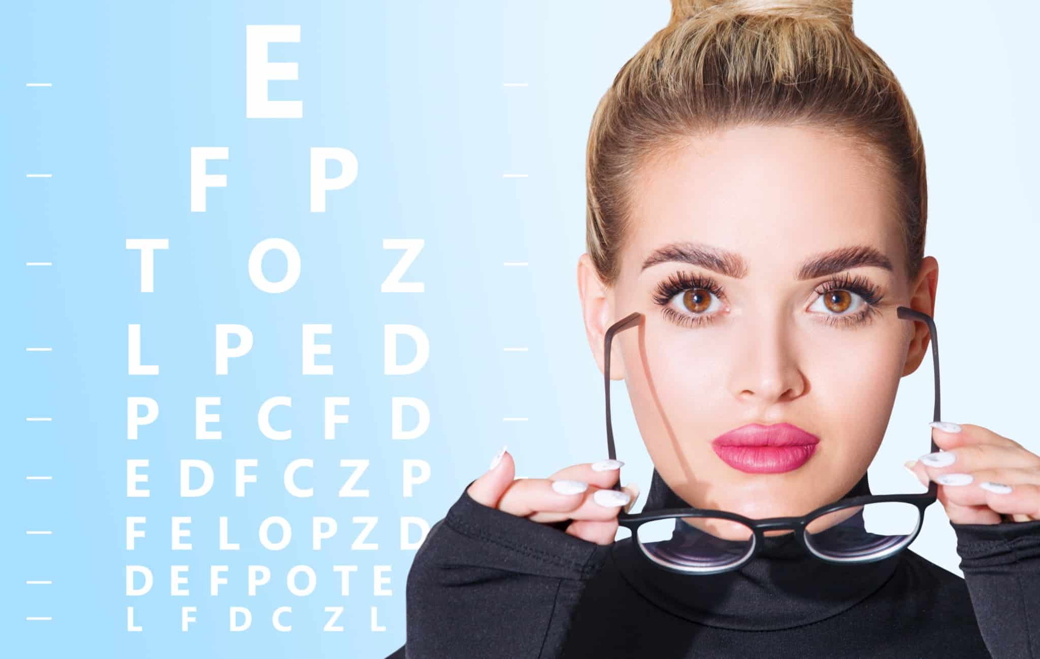 Young woman removes her eyeglasses, wondering whether she qualifies for premium lens replacement surgery