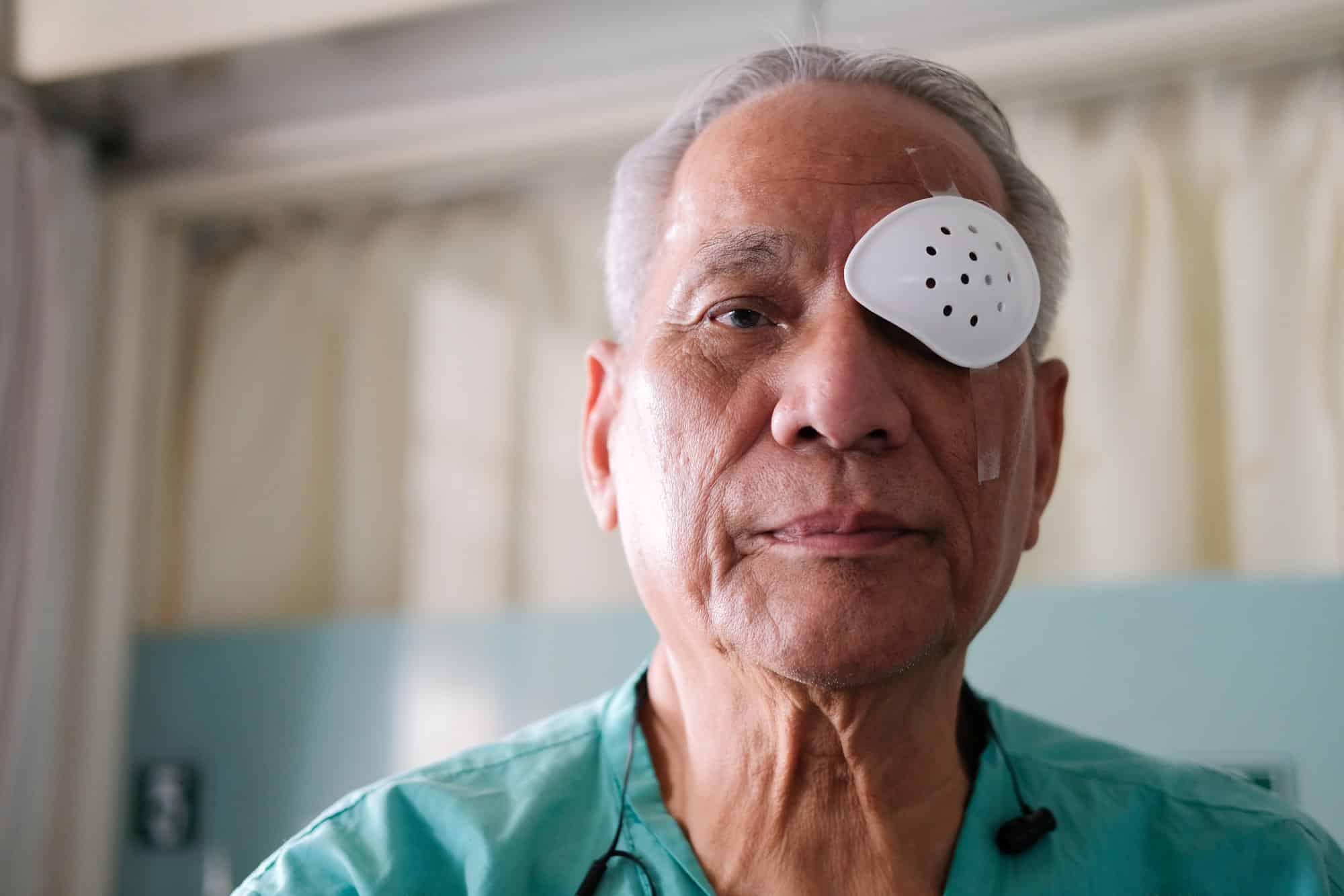 White-haired man in Austin, with a patch over one eye after premium lens replacement
